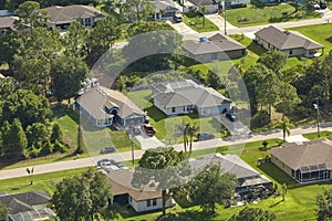 Aerial landscape view of suburban private houses between green palm trees in Florida quiet rural area