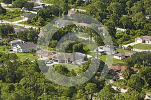 Aerial landscape view of suburban private houses between green palm trees in Florida quiet rural area