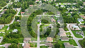 Aerial landscape view of suburban private houses between green palm trees in Florida quiet rural area