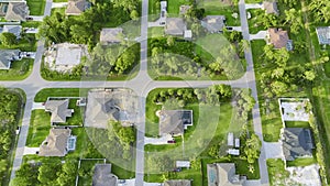 Aerial landscape view of suburban private houses between green palm trees in Florida quiet rural area