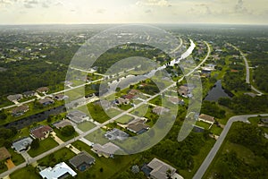 Aerial landscape view of suburban private houses between green palm trees in Florida quiet rural area