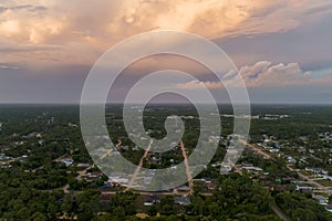 Aerial landscape view of suburban private houses between green palm trees in Florida quiet rural area at sunset