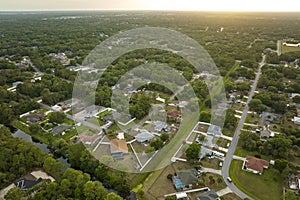 Aerial landscape view of suburban private houses between green palm trees in Florida rural area