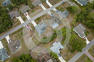 Aerial landscape view of suburban private houses between green palm trees in Florida rural area