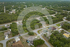 Aerial landscape view of suburban private houses between green palm trees in Florida rural area