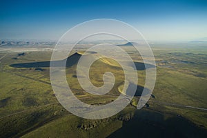 Aerial landscape of volcanic crater in Turkey. Stunned view of green valley with mountains and crater lake