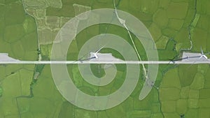 Aerial landscape wind turbine on green field for generation wind energy. Drone view windmill power station. Modern