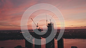 AERIAL: Manhattan, New York City High Rise Construction Site Crane in Red Dawn Sunset Light