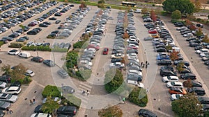 Aerial many cars parked on public city carpark. Automobiles riding large parking