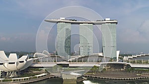 Aerial for Marina Bay Sands resort under cloudy blue sky in Singapore. Shot. Singapore skyline and aerial view of Marina