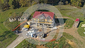 AERIAL: Massive drill bores a hole in the ground next to a CLT housing project.