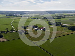 Aerial of meadowland and farms on the dutch island of Texel with the sea visible on the horizon