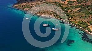 Aerial mediterranean sea landscape with boat, yachts, turquoise clear water and bay coastline