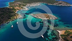 Aerial mediterranean sea landscape with boats, yachts, turquoise clear water, bay coastline and islands