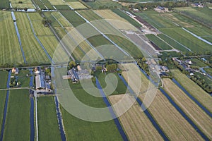 Aerial of modern farms with solar panels on the roof in dutch meadow landscape