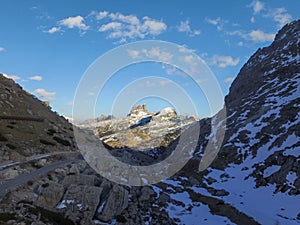 Aerial of Monte Averau in the Dolomites above Passo Falzarego. Monte Averau in the Sun, looking through a dark Valley in Shadow