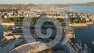 Aerial morning shot of Kerkyra, capital of Corfu island, Greece. Flying over buildings, park and sea in Kerkyra, Corfu