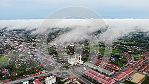 Aerial Morning view of Al-Ismaili Mosque covered with thick fog at Pasir Pekan Kelantan Malaysia