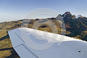 Aerial of Mount Kenya, Africa with airplane wing in foreground, the second highest mountain at 17,058 feet or 5199 Meters