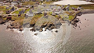 Aerial Newfoundland homes on rocky Atlantic Ocean shores at Bonavista Canada.