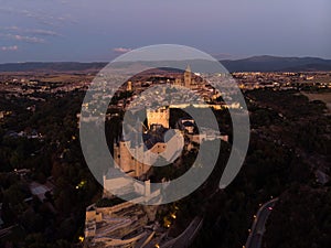 Aerial night panorama of illuminated Segovia old town historic centre Alcazar and Cathedral in Castile and Leon Spain