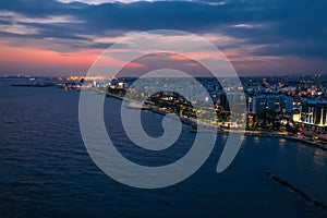 Aerial night panorama of Limassol, Cyprus waterfront. Famous mediterranean city resort in evening with Molos Park