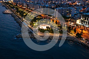 Aerial night panorama of Limassol, Cyprus waterfront. Famous mediterranean city resort in evening with Molos Park