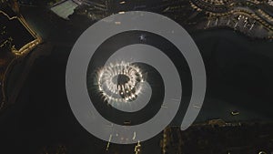 Aerial night shot of the choreographed water fountain in Dubai. At the foot of Burj Khalifa