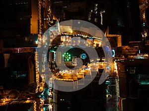 Aerial night shot of city during Christmas, winter and christmas decorations on square. Chistmas market during holiday