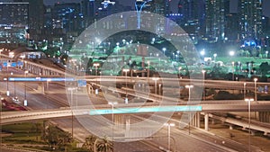 Aerial night view of empty highway and interchange without cars in Dubai