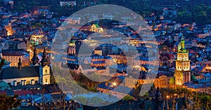 Aerial night view of historical old city district with churches, cathedrals and houses roofs in Lviv, Ukraine