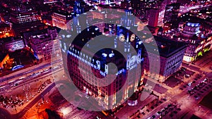 Aerial night view of an illuminated historic building in an urban setting with city lights in Liverpool, UK