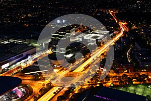 Aerial night view of modern city with circle road intersection