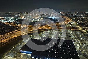 Aerial night view of place for vehicles in front of a shopping mall in Tampa. Many cars parked on parking lot with lines