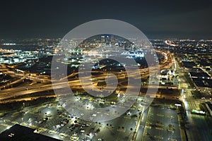 Aerial night view of place for vehicles in front of a shopping mall in Tampa. Many cars parked on parking lot with lines