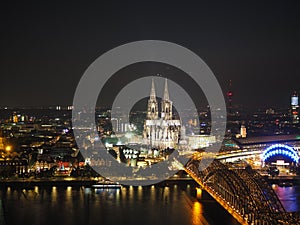 Aerial night view of St Peter Cathedral and Hohenzollern Bridge