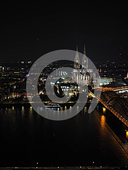 Aerial night view of St Peter Cathedral and Hohenzollern Bridge