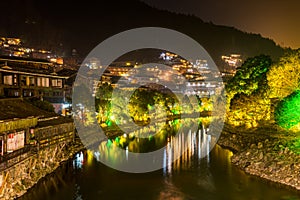 Aerial night view of traditional wooden building cluster of Xijiang Qianhu Miao Village The One Thousand Household Miao Village