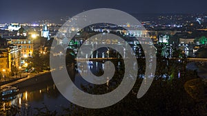 Aerial night view of the Vltava River and illuminated bridges timelapse, Prague