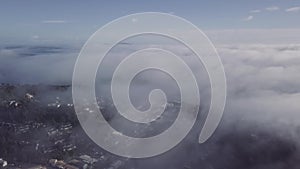 Aerial, ocean fog covers small New Zealand Town 4k