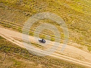 Aerial off-road truck in the summer green field f