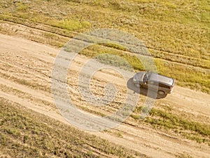 Aerial off-road truck in the summer green field f
