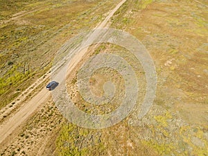 Aerial off-road truck in the summer green field f