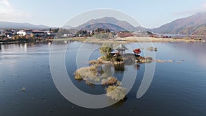 Aerial orbit shot at distance of Hexagonal japanese temple built in in Fuji Lake