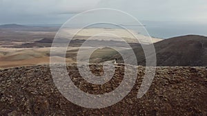 Aerial orbital clip of the volcanic crater ridge of Montana Roja Fuerteventura