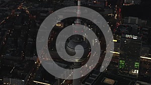 AERIAL: Over Berlin Germany TV Tower Alexanderplatz at Night with City Lights traffic