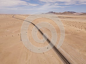 Aerial over railway tracks runnning through the desert