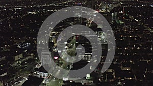 AERIAL: Over Wilshire Boulevard in Hollywood Los Angeles at Night with Glowing Streets and City Car Traffic Lights