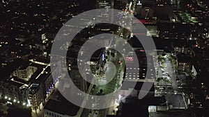 AERIAL: Over Wilshire Boulevard in Hollywood Los Angeles at Night with Glowing Streets and City Car Traffic Lights