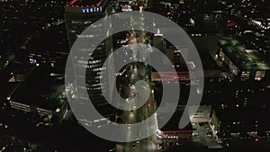 AERIAL: Over Wilshire Boulevard in Hollywood Los Angeles at Night with Glowing Streets and City Car Traffic Lights